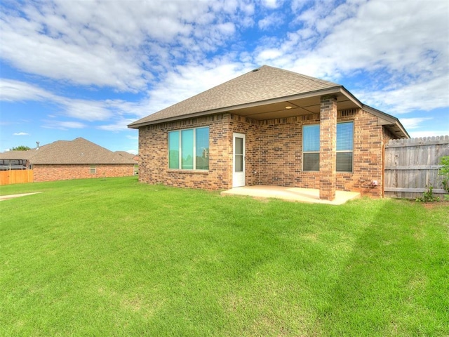 5512 Cheyenne Rd, Warr Acres, OK 73132 - rear view of house with a patio area, brick siding, and a shingled roof