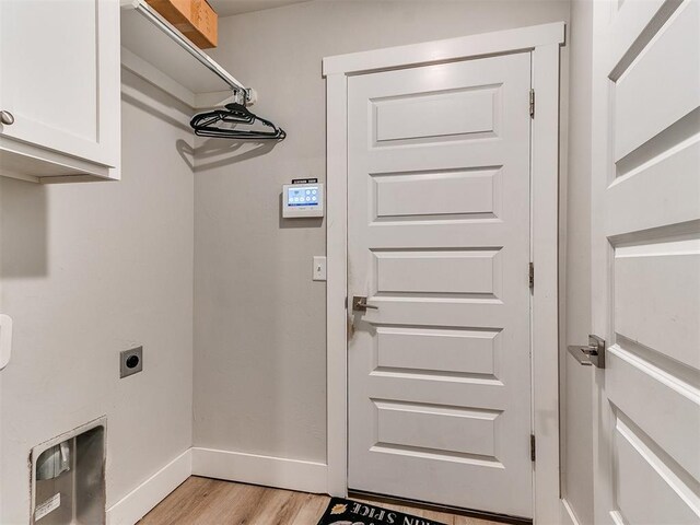 5512 Cheyenne Rd, Warr Acres, OK 73132 - washroom with cabinet space, electric dryer hookup, and light wood-style flooring