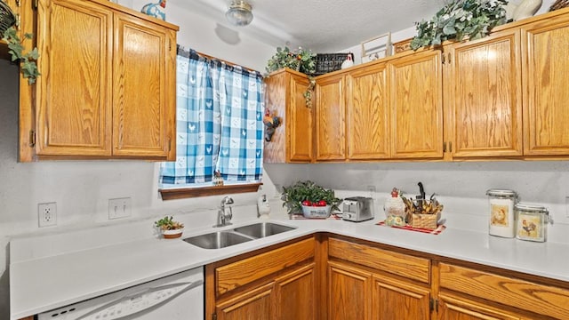 677 S Morgan Ave, Blanchard, OK 73010 - kitchen with dishwasher, light countertops, a textured ceiling, and brown cabinetry
