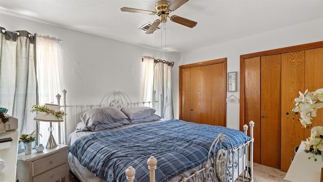 677 S Morgan Ave, Blanchard, OK 73010 - bedroom with multiple closets, multiple windows, carpet floors, and a ceiling fan