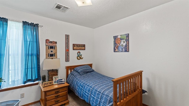 677 S Morgan Ave, Blanchard, OK 73010 - bedroom featuring carpet and a textured ceiling