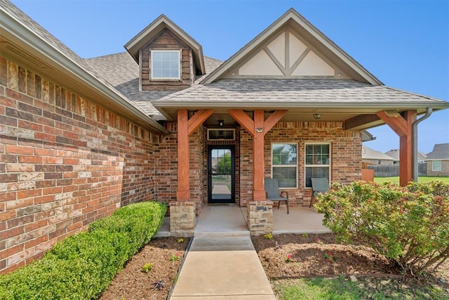 917 NW 186th St, Edmond, OK 73012 - property entrance with a shingled roof, brick siding, and a porch