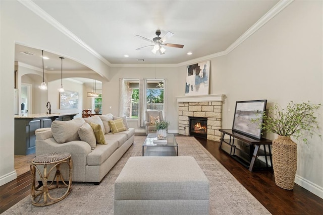 917 NW 186th St, Edmond, OK 73012 - living room with hardwood / wood-style flooring, ceiling fan, recessed lighting, a stone fireplace, and arched walkways