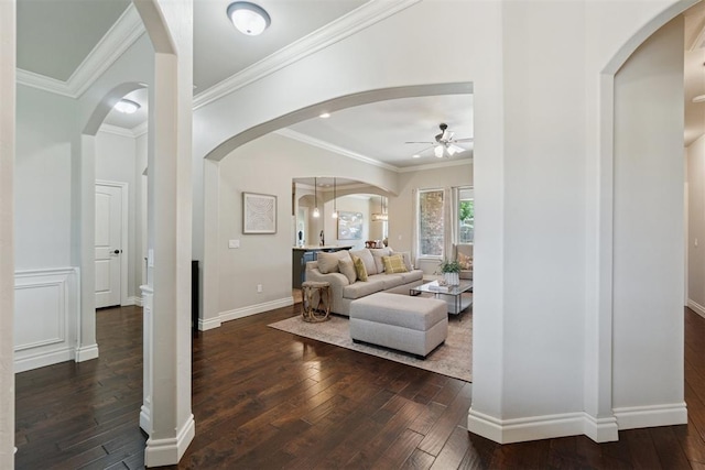 917 NW 186th St, Edmond, OK 73012 - living room with dark wood finished floors, ceiling fan, arched walkways, and crown molding