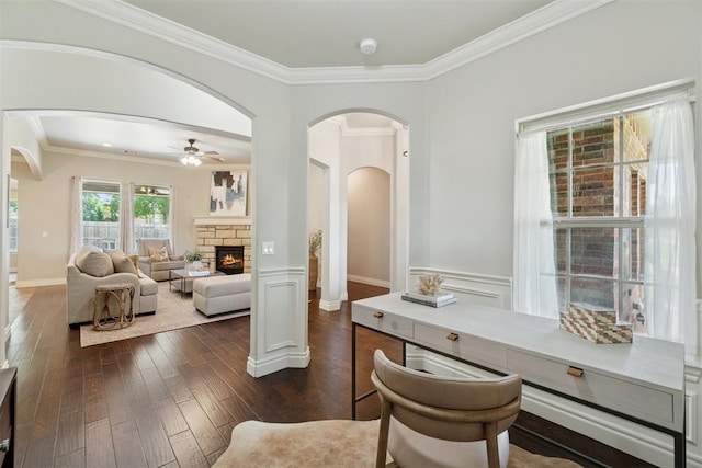 917 NW 186th St, Edmond, OK 73012 - office space with arched walkways, crown molding, dark wood-style flooring, ceiling fan, and a stone fireplace