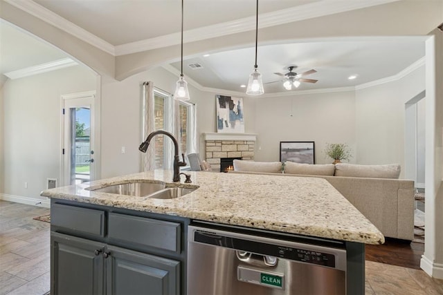 917 NW 186th St, Edmond, OK 73012 - kitchen featuring stainless steel dishwasher, a ceiling fan, gray cabinets, a stone fireplace, and light stone counters
