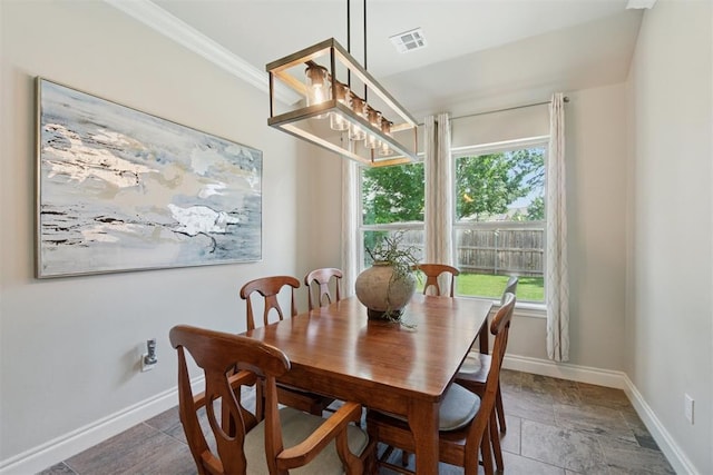 917 NW 186th St, Edmond, OK 73012 - dining space featuring healthy amount of natural light, ornamental molding, stone finish flooring, and a chandelier