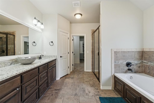 917 NW 186th St, Edmond, OK 73012 - full bath featuring vanity, a garden tub, and a shower stall