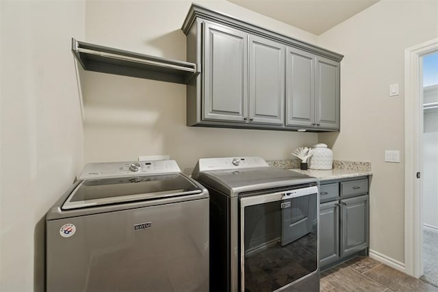917 NW 186th St, Edmond, OK 73012 - laundry area featuring independent washer and dryer and cabinet space
