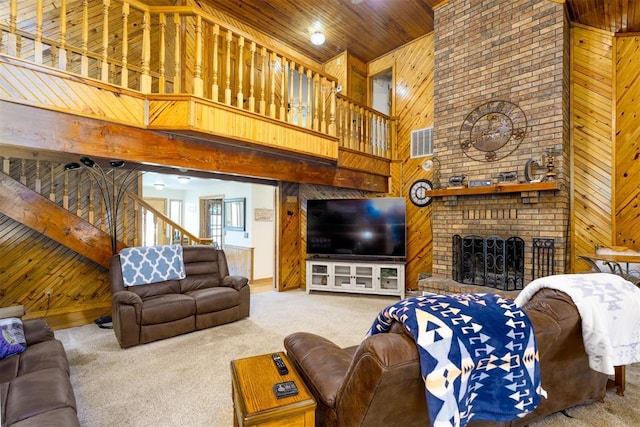 498 Big Horn Rd, Mcalester, OK 74501 - living room with a high ceiling, wood walls, carpet floors, wooden ceiling, and a brick fireplace