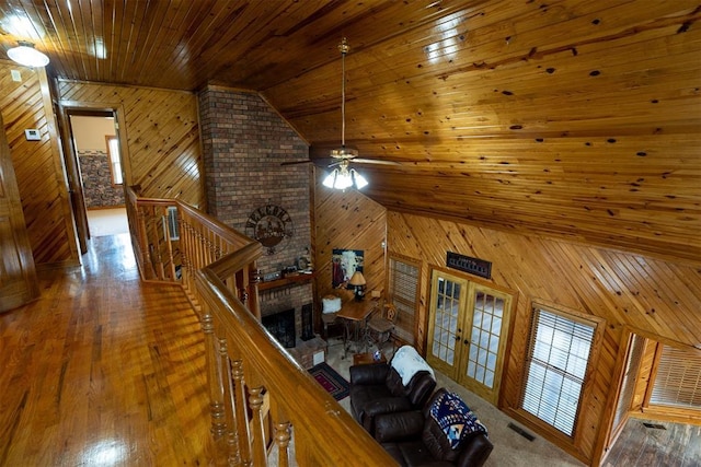 498 Big Horn Rd, Mcalester, OK 74501 - living area featuring wood walls, wooden ceiling, a ceiling fan, french doors, and wood finished floors