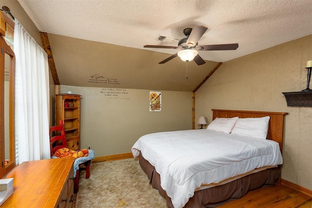 498 Big Horn Rd, Mcalester, OK 74501 - bedroom featuring vaulted ceiling, a textured ceiling, wood finished floors, and ceiling fan