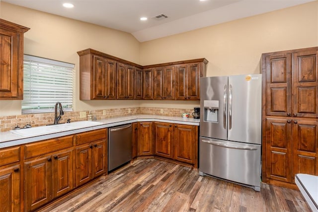 498 Big Horn Rd, Mcalester, OK 74501 - kitchen featuring stainless steel appliances, light countertops, dark wood finished floors, backsplash, and recessed lighting