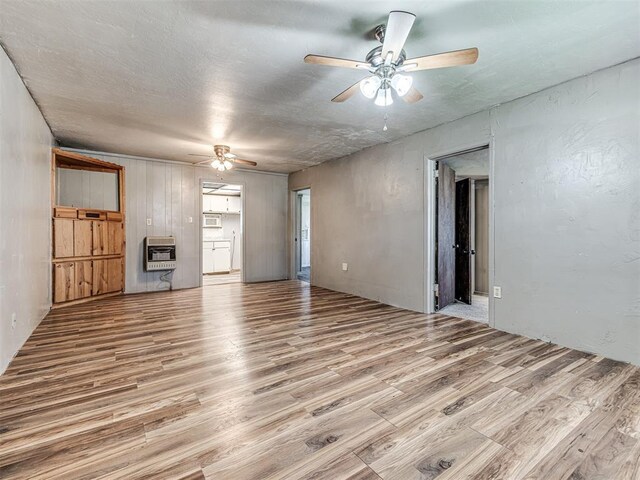 211 S 6th St, Mcloud, OK 74851 - unfurnished living room with ceiling fan, light wood finished floors, and heating unit