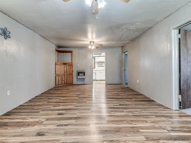 211 S 6th St, Mcloud, OK 74851 - unfurnished living room featuring ceiling fan, heating unit, and wood finished floors