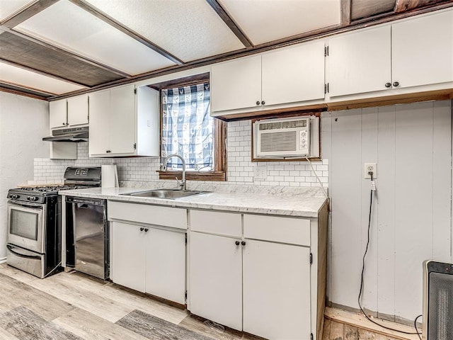 211 S 6th St, Mcloud, OK 74851 - kitchen featuring range with gas stovetop, a sink, light wood-style floors, decorative backsplash, and under cabinet range hood