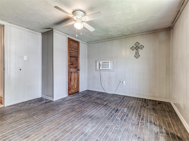 211 S 6th St, Mcloud, OK 74851 - unfurnished room with wood-type flooring, an AC wall unit, a ceiling fan, baseboards, and wood walls
