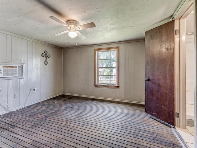 211 S 6th St, Mcloud, OK 74851 - spare room with ceiling fan, an AC wall unit, and wood walls