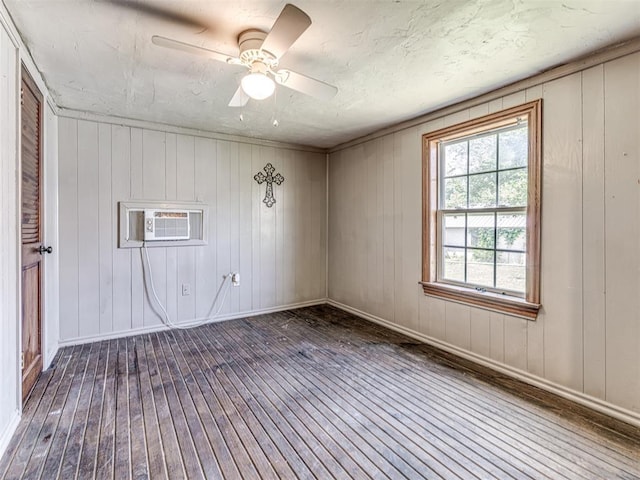211 S 6th St, Mcloud, OK 74851 - unfurnished room with hardwood / wood-style floors, baseboards, a wall unit AC, and a ceiling fan