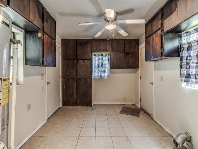 211 S 6th St, Mcloud, OK 74851 - kitchen featuring a ceiling fan, dark brown cabinets, and light tile patterned flooring