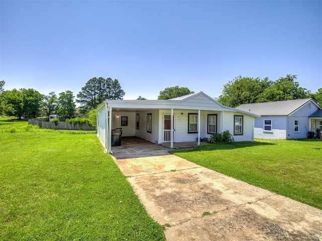 211 S 6th St, Mcloud, OK 74851 - view of front of home with driveway, a carport, and a porch