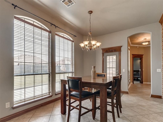 1316 NW 171st St, Edmond, OK 73012 - dining room with plenty of natural light, arched walkways, light tile patterned floors, and a chandelier