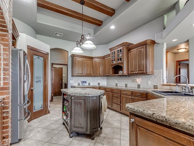 1316 NW 171st St, Edmond, OK 73012 - kitchen with freestanding refrigerator, open shelves, backsplash, decorative light fixtures, and light stone counters