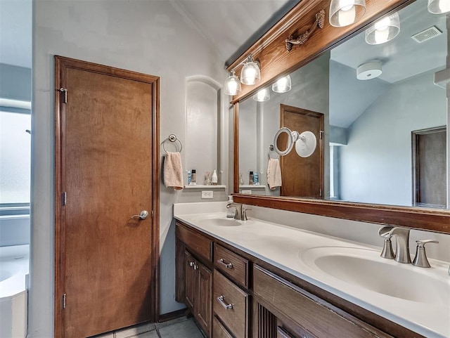 1316 NW 171st St, Edmond, OK 73012 - bathroom featuring lofted ceiling, double vanity, and tile patterned flooring