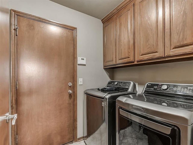 1316 NW 171st St, Edmond, OK 73012 - laundry room with washer and clothes dryer, cabinet space, and light tile patterned floors