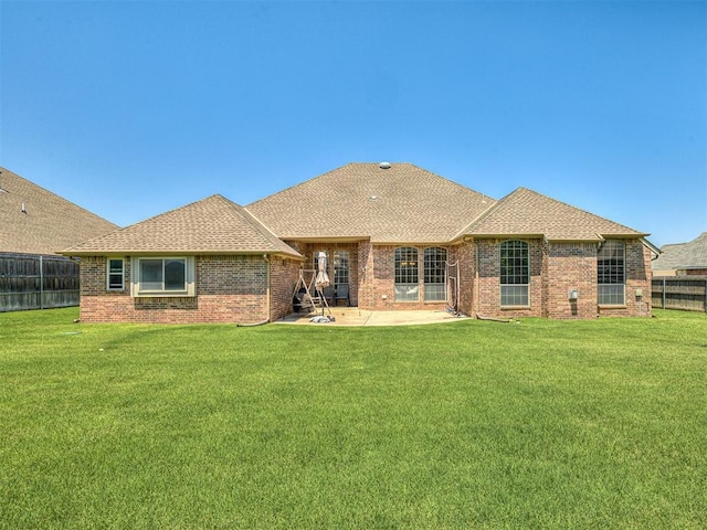 1316 NW 171st St, Edmond, OK 73012 - rear view of property with a patio area, a fenced backyard, brick siding, and roof with shingles