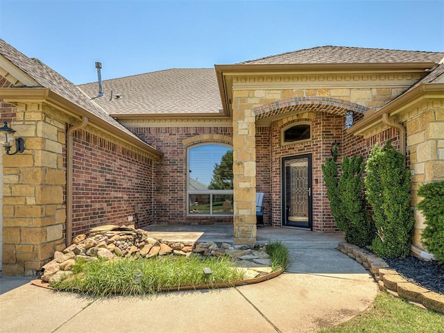 1316 NW 171st St, Edmond, OK 73012 - entrance to property with brick siding, roof with shingles, and stone siding