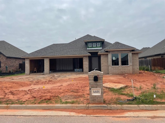 4601 Hidalgo Ave, Mustang, OK 73064 - view of front of house featuring a garage, brick siding, a shingled roof, and driveway