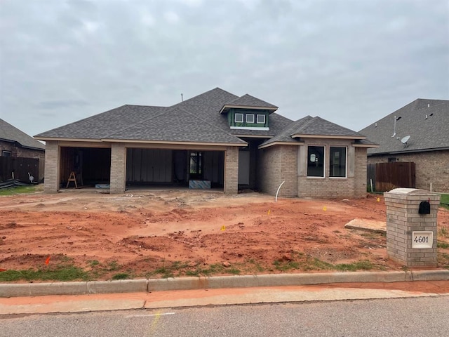 4601 Hidalgo Ave, Mustang, OK 73064 - view of front of property featuring a garage, a shingled roof, and brick siding