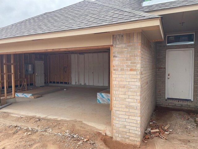 4601 Hidalgo Ave, Mustang, OK 73064 - property entrance with roof with shingles and brick siding