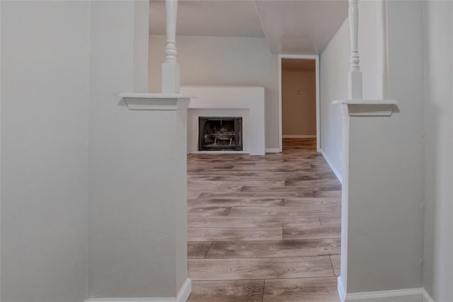 1725 E Lindsey St Unit 2, Norman, OK 73071 - hallway featuring wood finished floors and baseboards