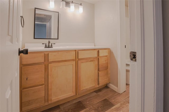 1725 E Lindsey St Unit 2, Norman, OK 73071 - bathroom with wood finished floors and vanity