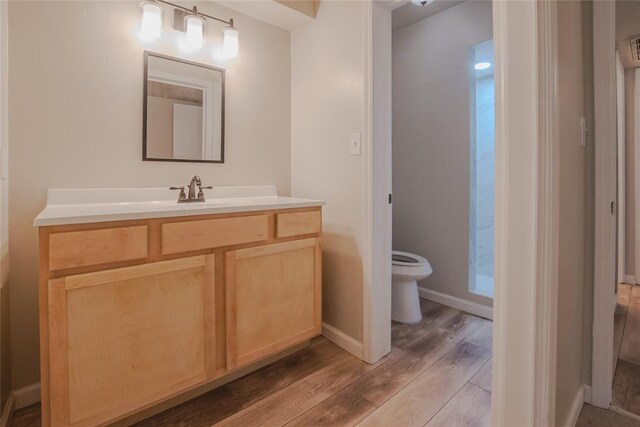 1725 E Lindsey St Unit 2, Norman, OK 73071 - bathroom with wood finished floors and vanity
