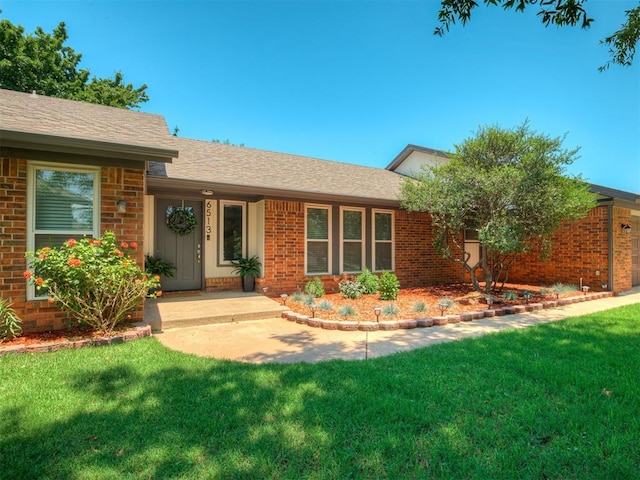 6513 NW 95th St, Oklahoma City, OK 73162 - ranch-style home featuring brick siding, a front lawn, and roof with shingles
