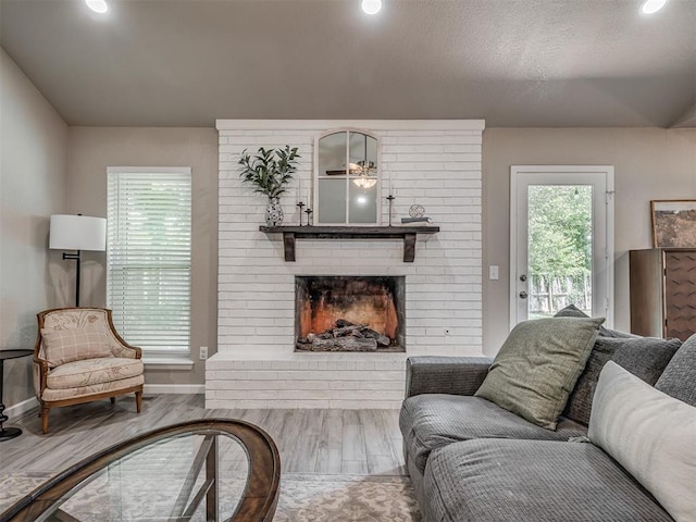 6513 NW 95th St, Oklahoma City, OK 73162 - living room with a brick fireplace, baseboards, wood finished floors, ceiling fan, and recessed lighting