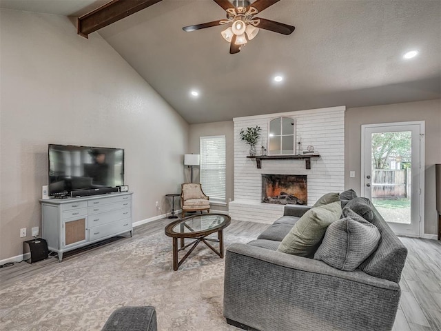 6513 NW 95th St, Oklahoma City, OK 73162 - living room with light wood finished floors, beamed ceiling, ceiling fan, baseboards, and a fireplace