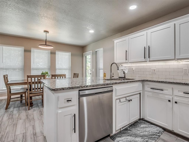 6513 NW 95th St, Oklahoma City, OK 73162 - kitchen with dishwasher, a peninsula, a sink, white cabinets, and tasteful backsplash