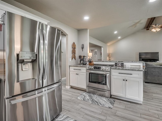6513 NW 95th St, Oklahoma City, OK 73162 - kitchen with stainless steel appliances, open floor plan, a peninsula, white cabinetry, and light stone countertops