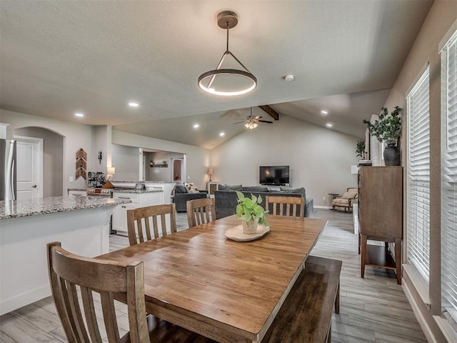 6513 NW 95th St, Oklahoma City, OK 73162 - dining area with a ceiling fan, arched walkways, light wood-style flooring, lofted ceiling, and recessed lighting