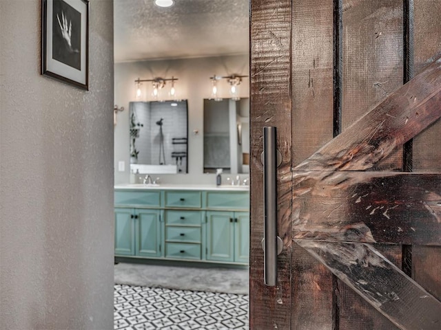 6513 NW 95th St, Oklahoma City, OK 73162 - full bath with double vanity, a textured wall, and a textured ceiling
