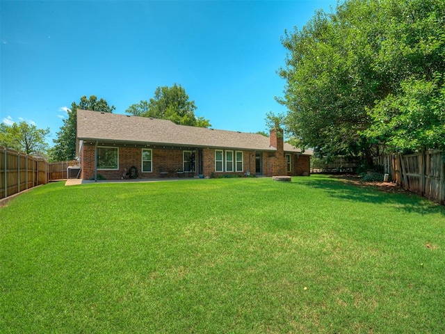 6513 NW 95th St, Oklahoma City, OK 73162 - rear view of property with a chimney and brick siding