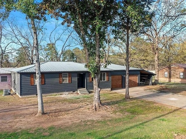 309 E Memorial St, Broken Bow, OK 74728 - ranch-style house featuring driveway, metal roof, and central AC