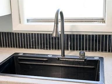 309 E Memorial St, Broken Bow, OK 74728 - kitchen view of a sink and white cabinetry