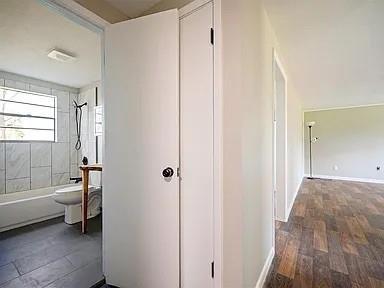 309 E Memorial St, Broken Bow, OK 74728 - hallway featuring baseboards