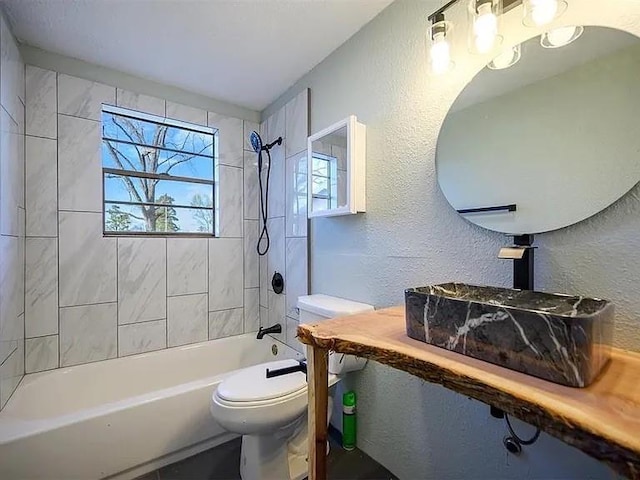 309 E Memorial St, Broken Bow, OK 74728 - full bath featuring plenty of natural light, a textured wall, toilet, and shower / bathtub combination