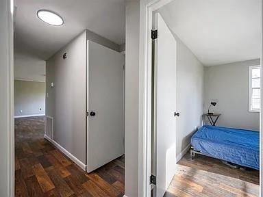 309 E Memorial St, Broken Bow, OK 74728 - corridor featuring wood finished floors and baseboards